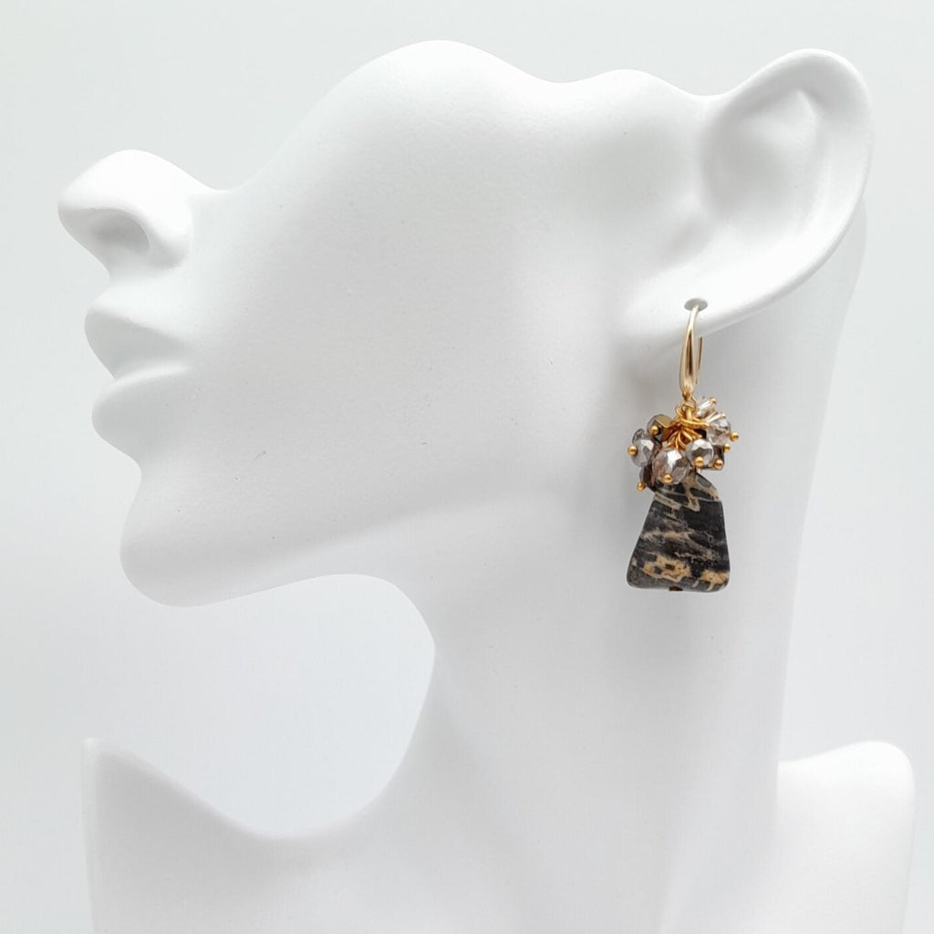 Earrings on a white mannequin bust with a plain background