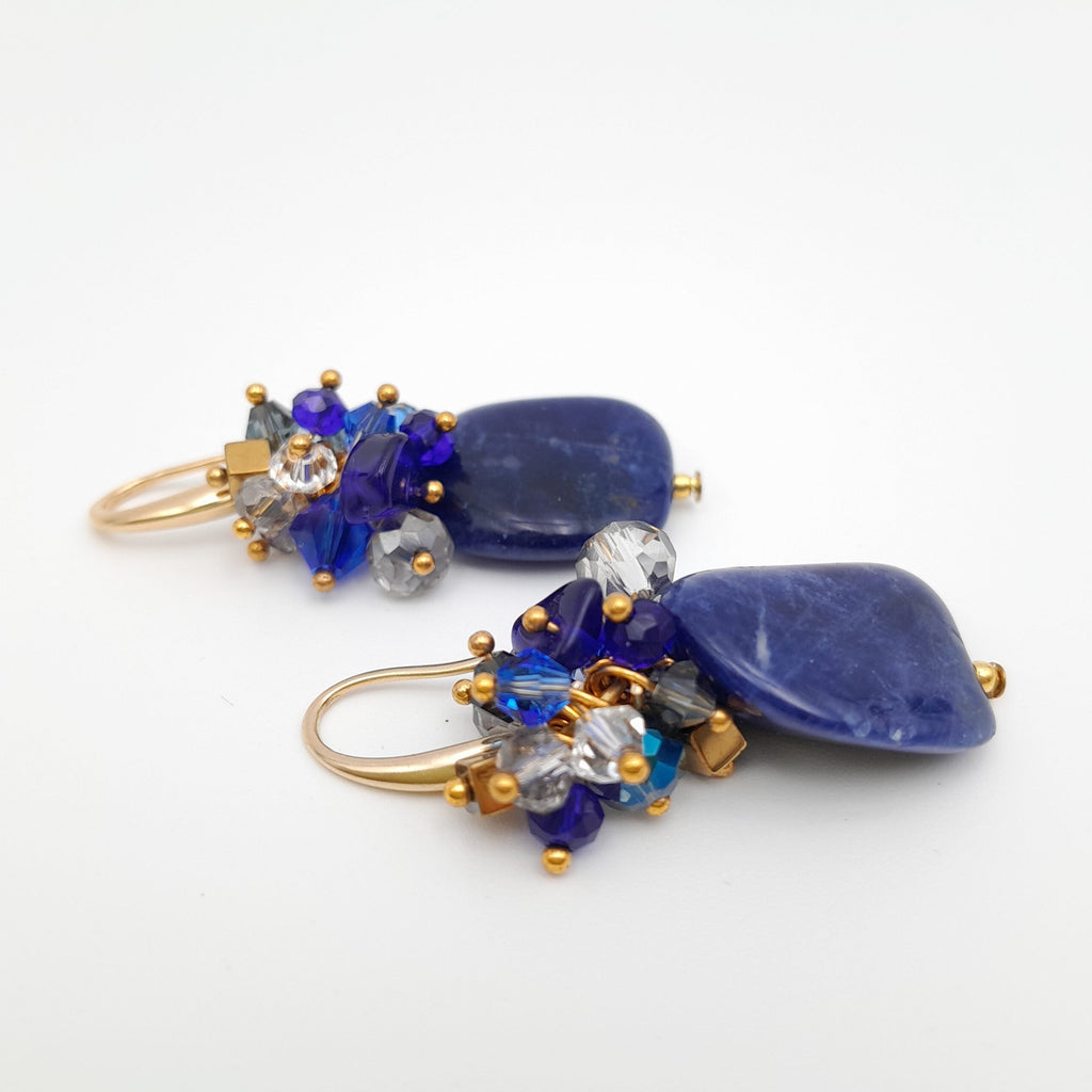 Jewelry set with blue and gold elements on a white background