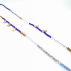 Necklace with blue, white, and gold beads on a white background