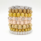 Stack of colorful beaded bracelets on a white background