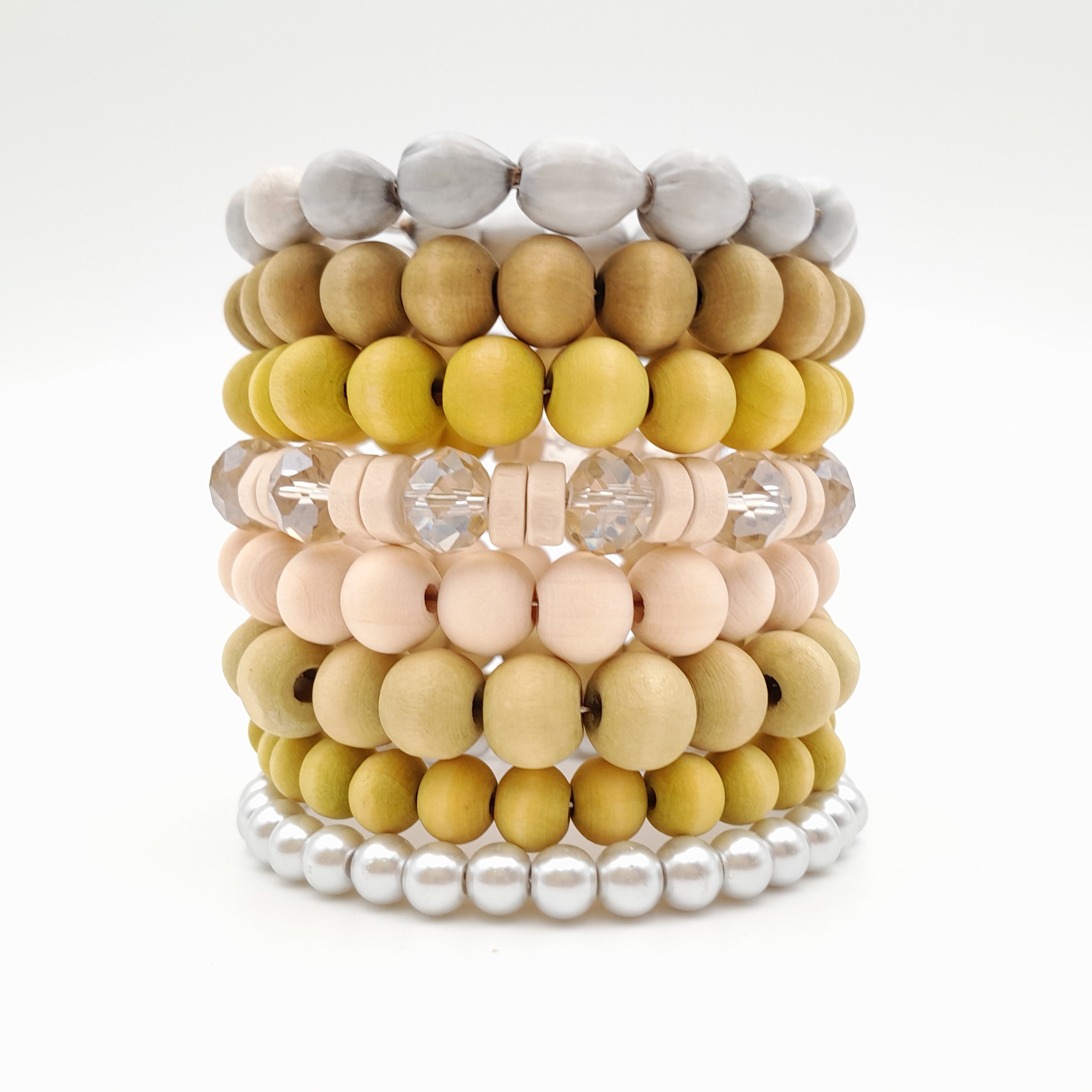 Stack of colorful beaded bracelets on a white background