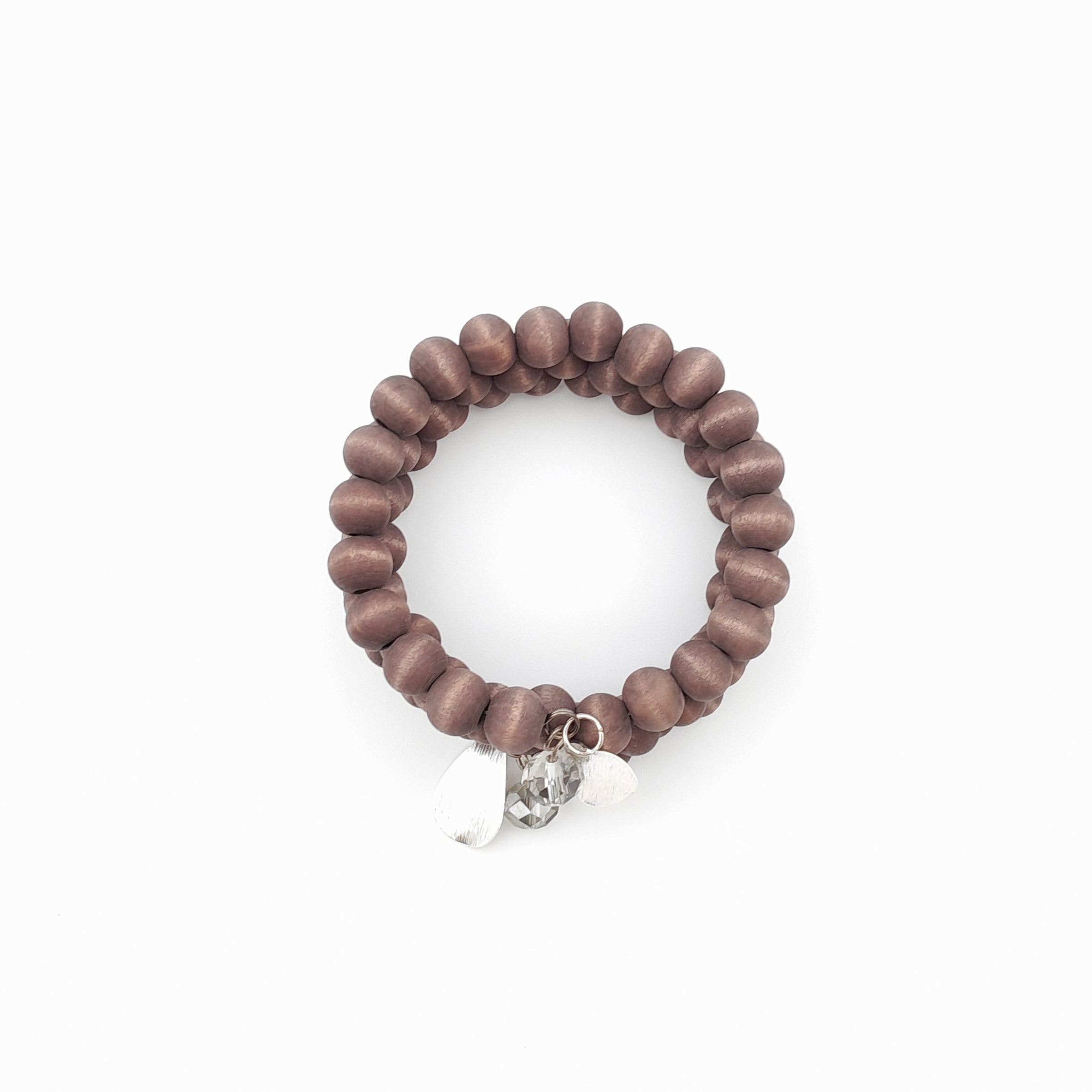 Wooden beaded bracelet with silver charms on a white background