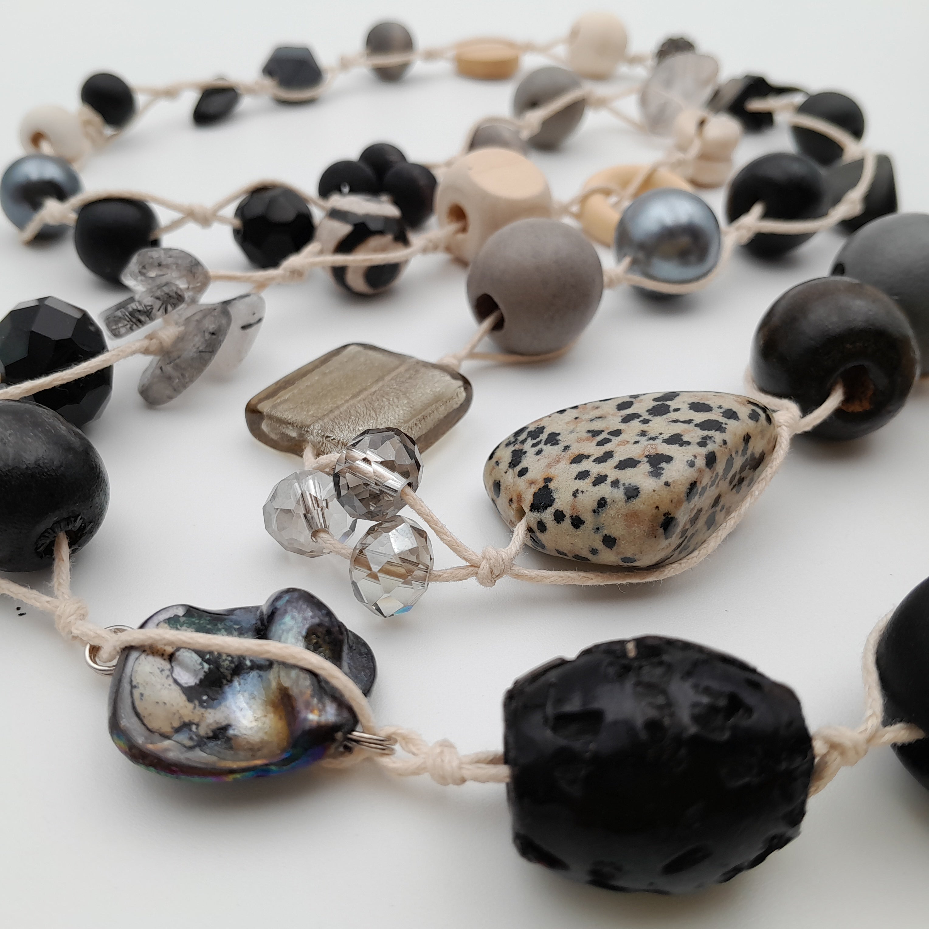 Necklace with various beads, semi-precious gemstones and shell beads on a white background