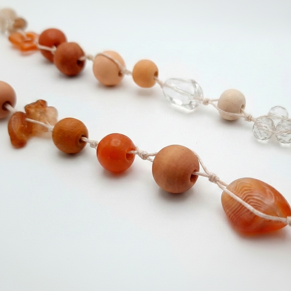 Necklace with orange and beige beads on a white background