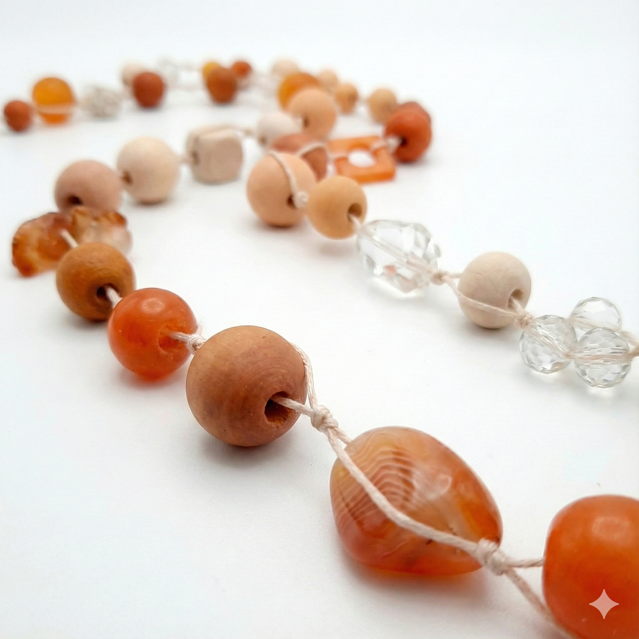 Necklace with wooden and orange beads on a white background
